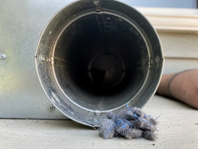 Kingston Dryer Vent Cleaning technician using specialized equipment to clear severe dryer vent blockage in Kingston